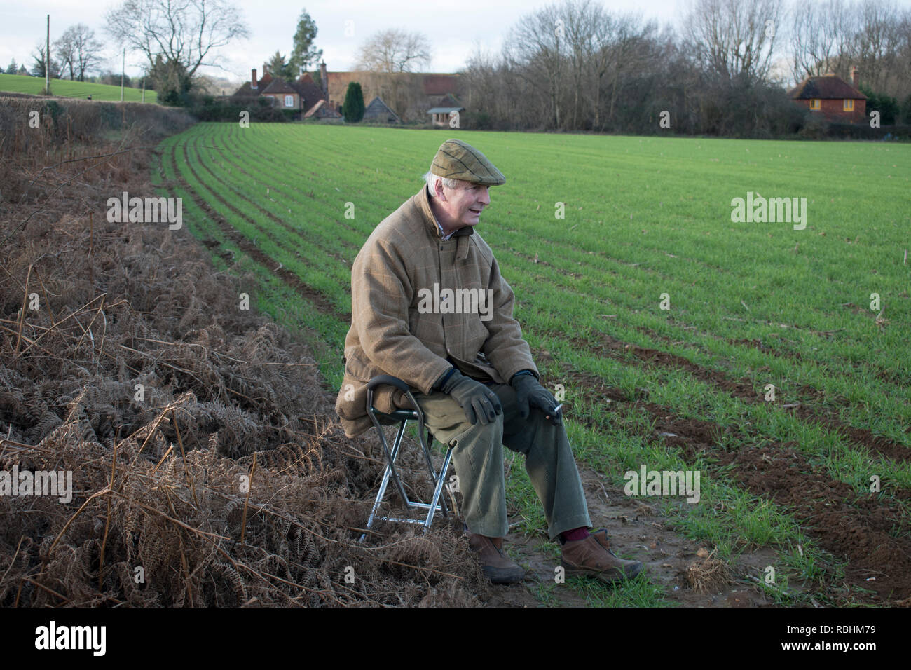 Shooting stick, older elderly man sitting in the countryside  Field Sports enthusiast. Midhurst West Sussex 2019. 2010s HOMER SYKES Stock Photo