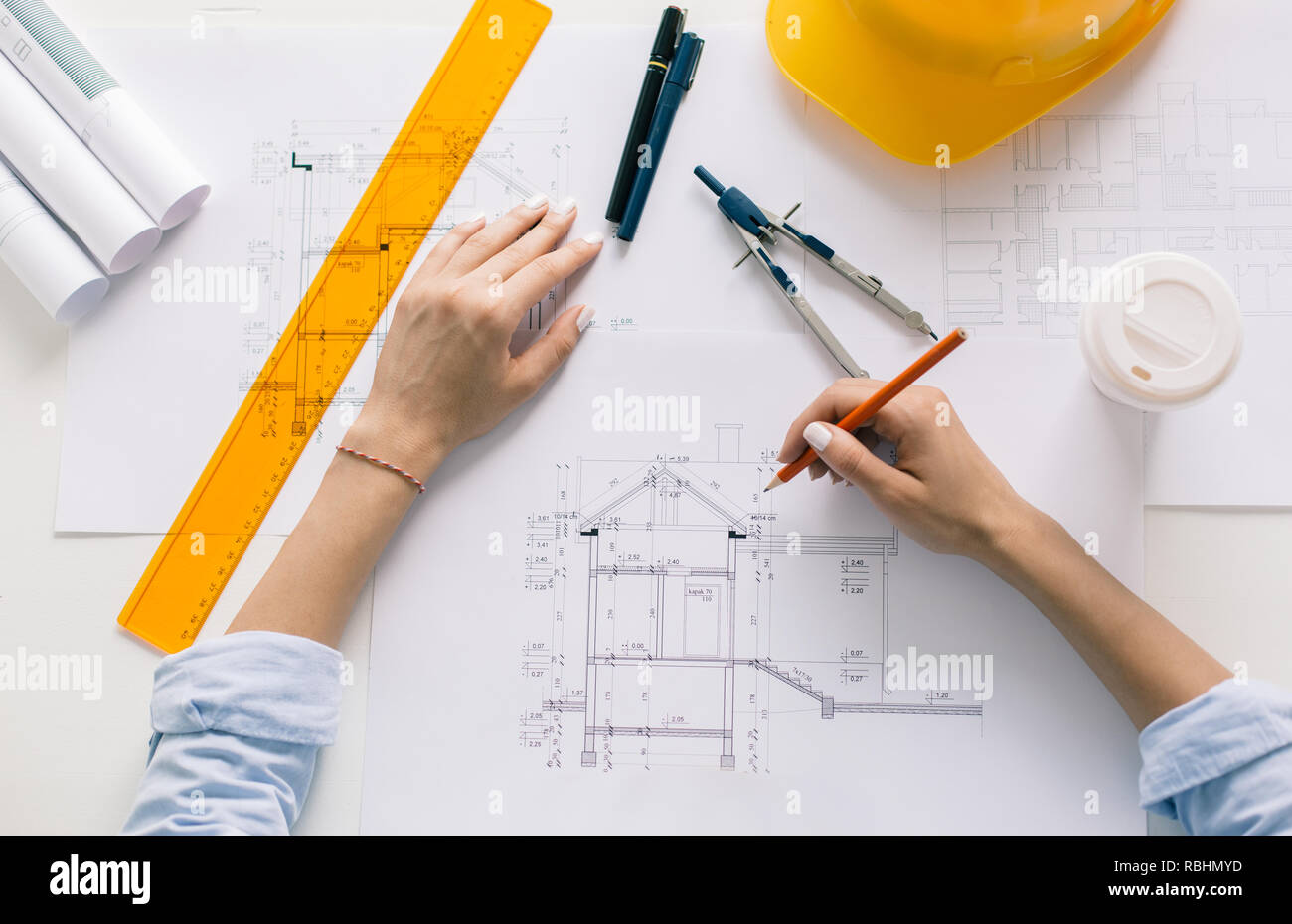 Architect drawing blueprints. Architectural/engineering project concept Stock Photo