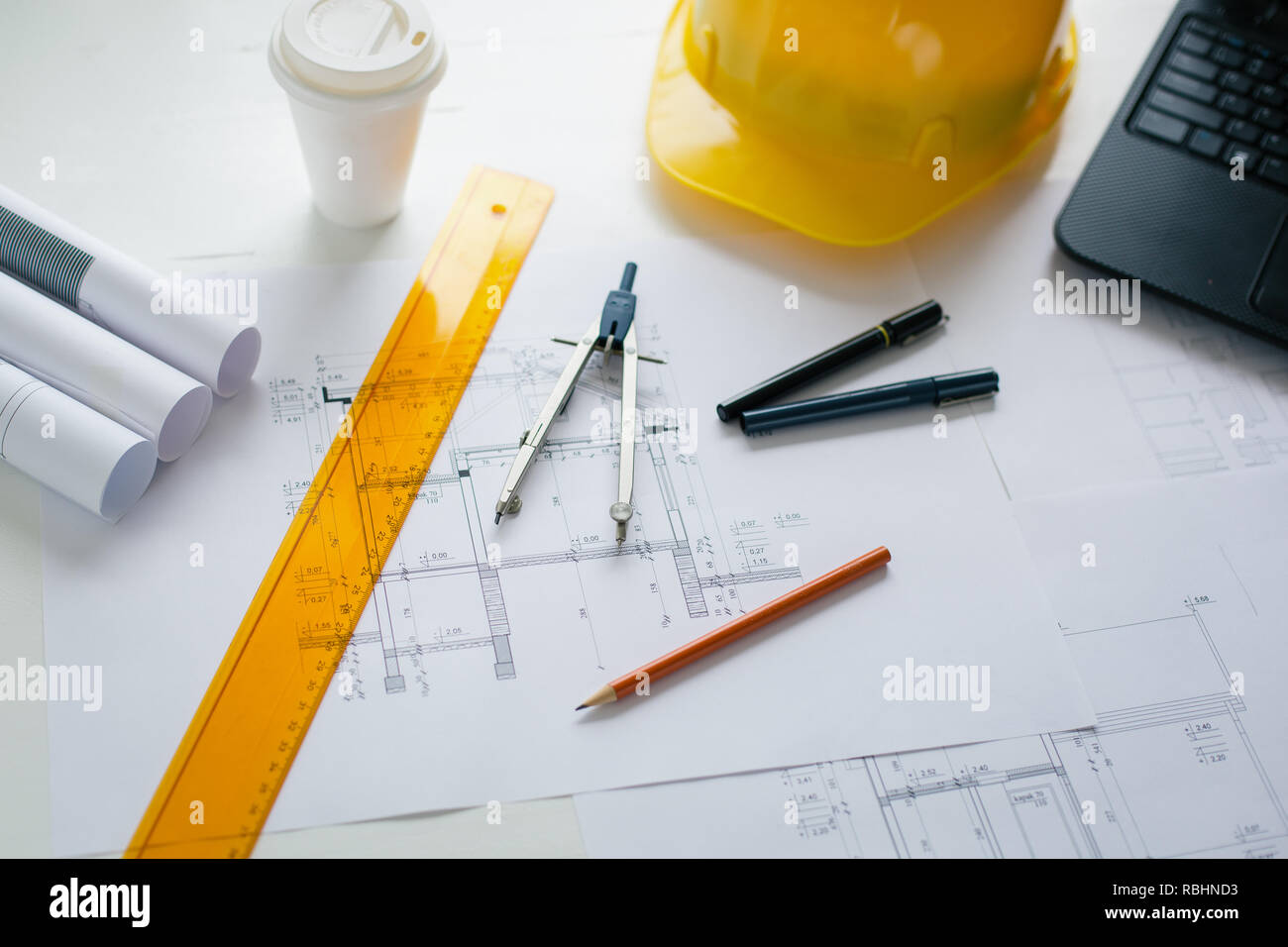 Engineers equipment and blueprints on the office desk. Construction