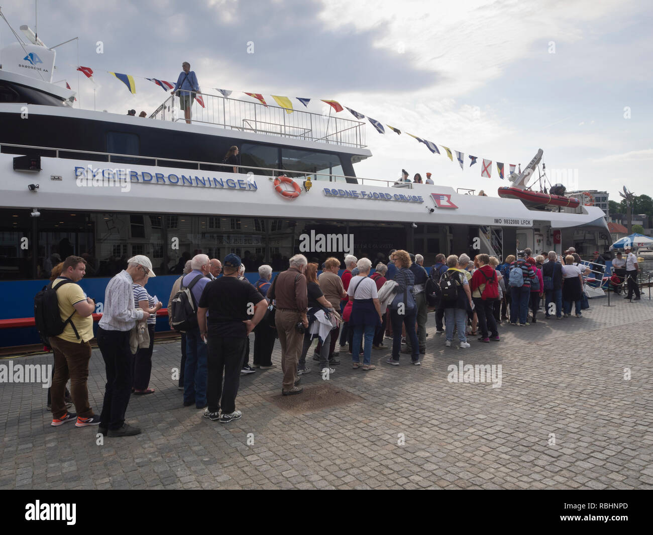 Tourists lining up for a popular day cruise from Stavanger Norway into the Lysefjorden under the Pulpit rock Stock Photo