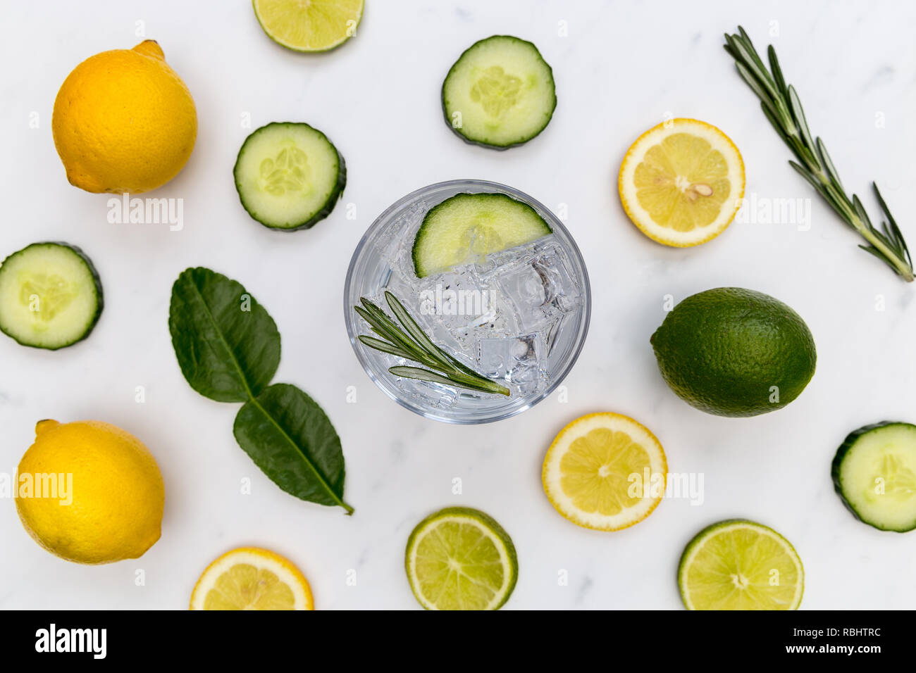 Gin tonic cocktail drink glass with ice cucumber lime lemon white background Stock Photo Alamy
