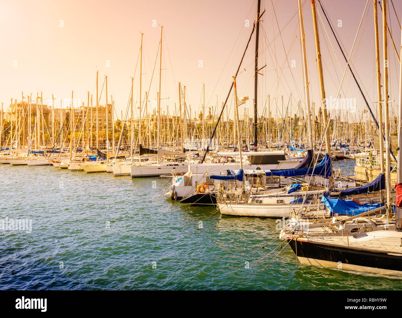 Sailboats docked at the marina in Barcelona on a bright spring day Stock Photo