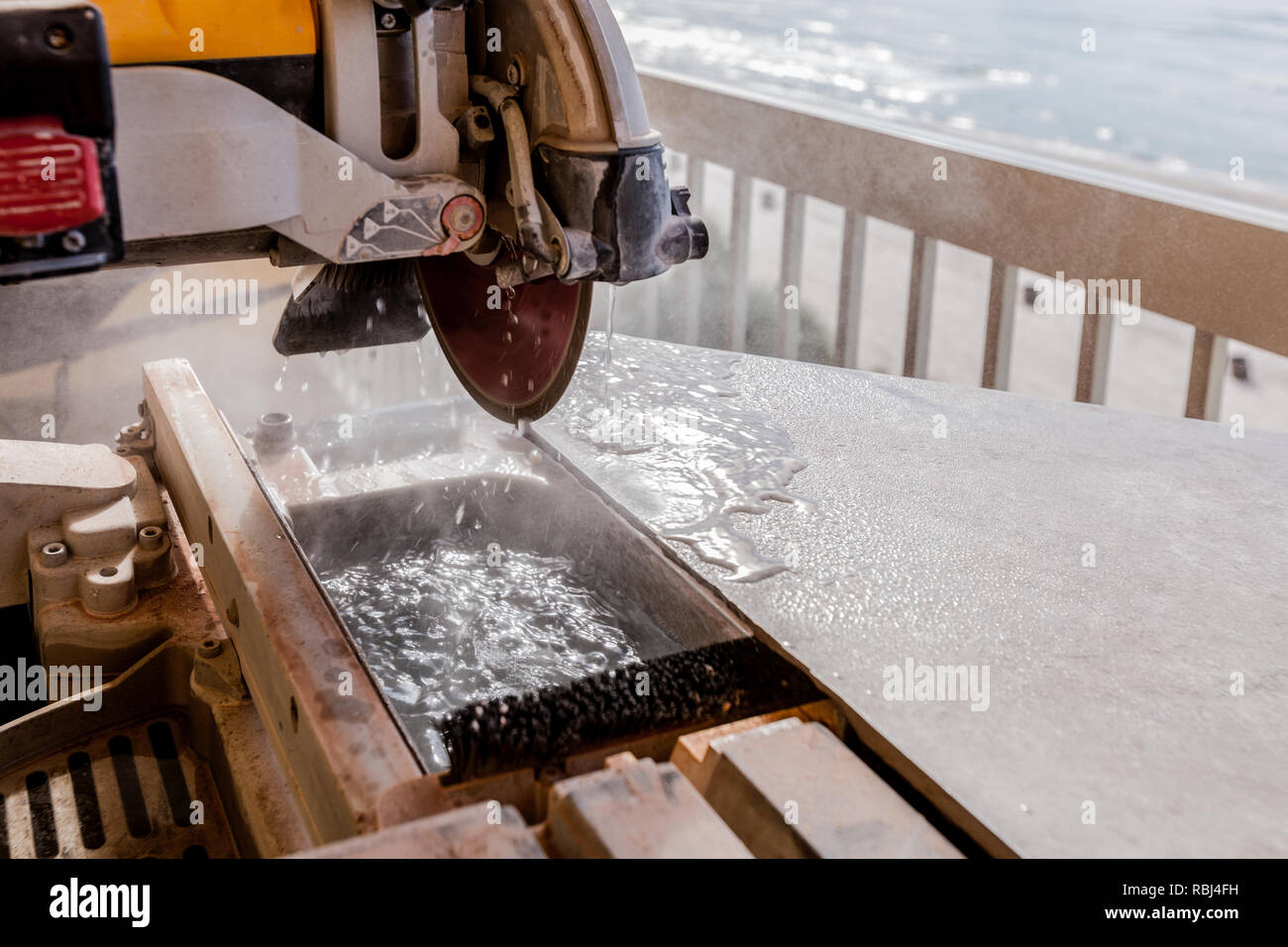 Wet Tile Saw Being Used To Cut Tile Stock Photo
