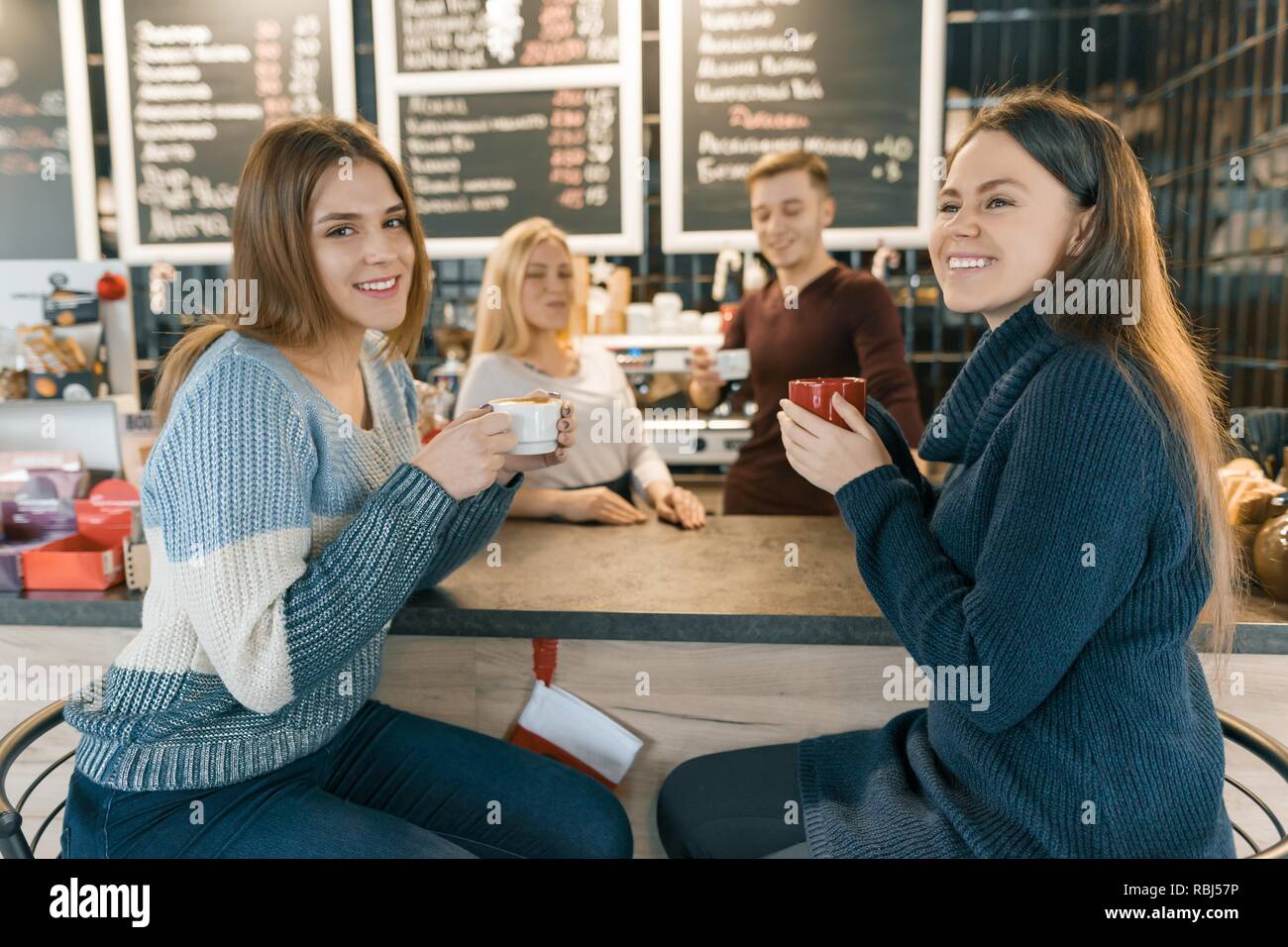 Young Women Drinking Coffee In Cafe Girls Sitting Near The Bar Counter Background Working Barista Making Coffee Stock Photo Alamy