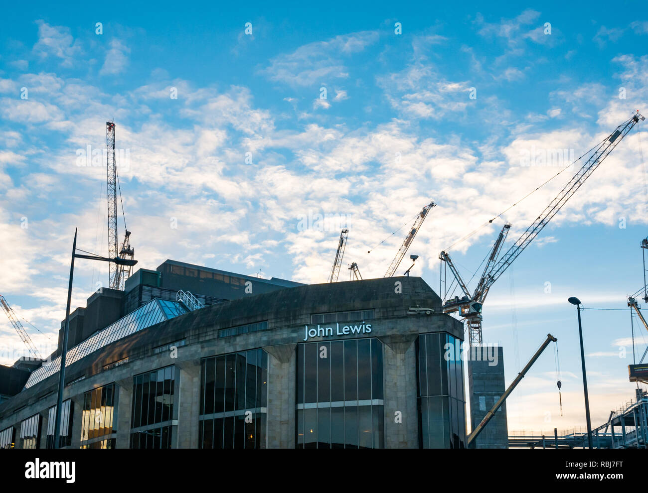 John Lewis department store front at dusk with St James construction site cranes, Edinburgh, Scotland, UK Stock Photo