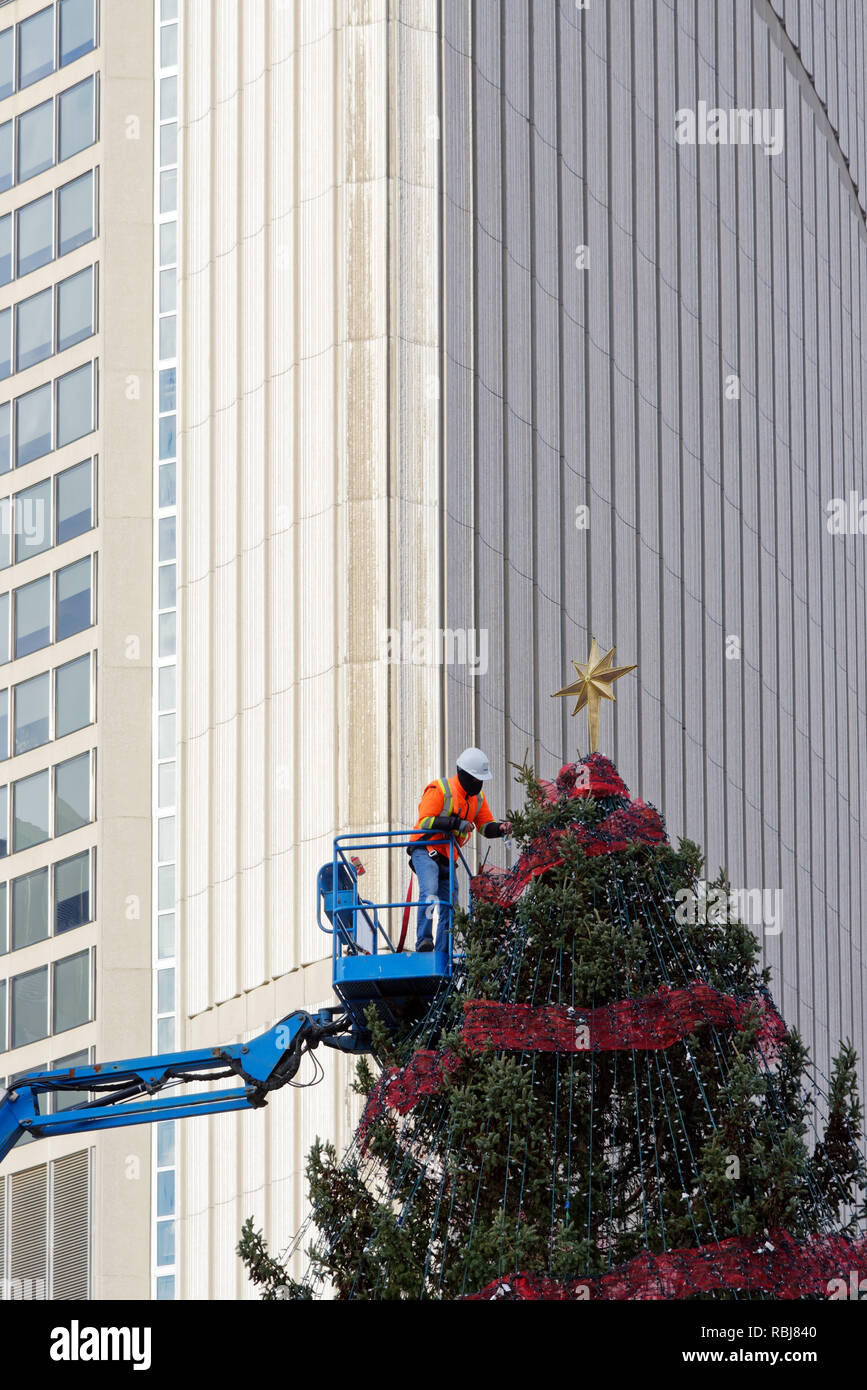 Workers putting the star on the Christmas tree in Nathan Phillips Square, Toronto, Canada Stock Photo