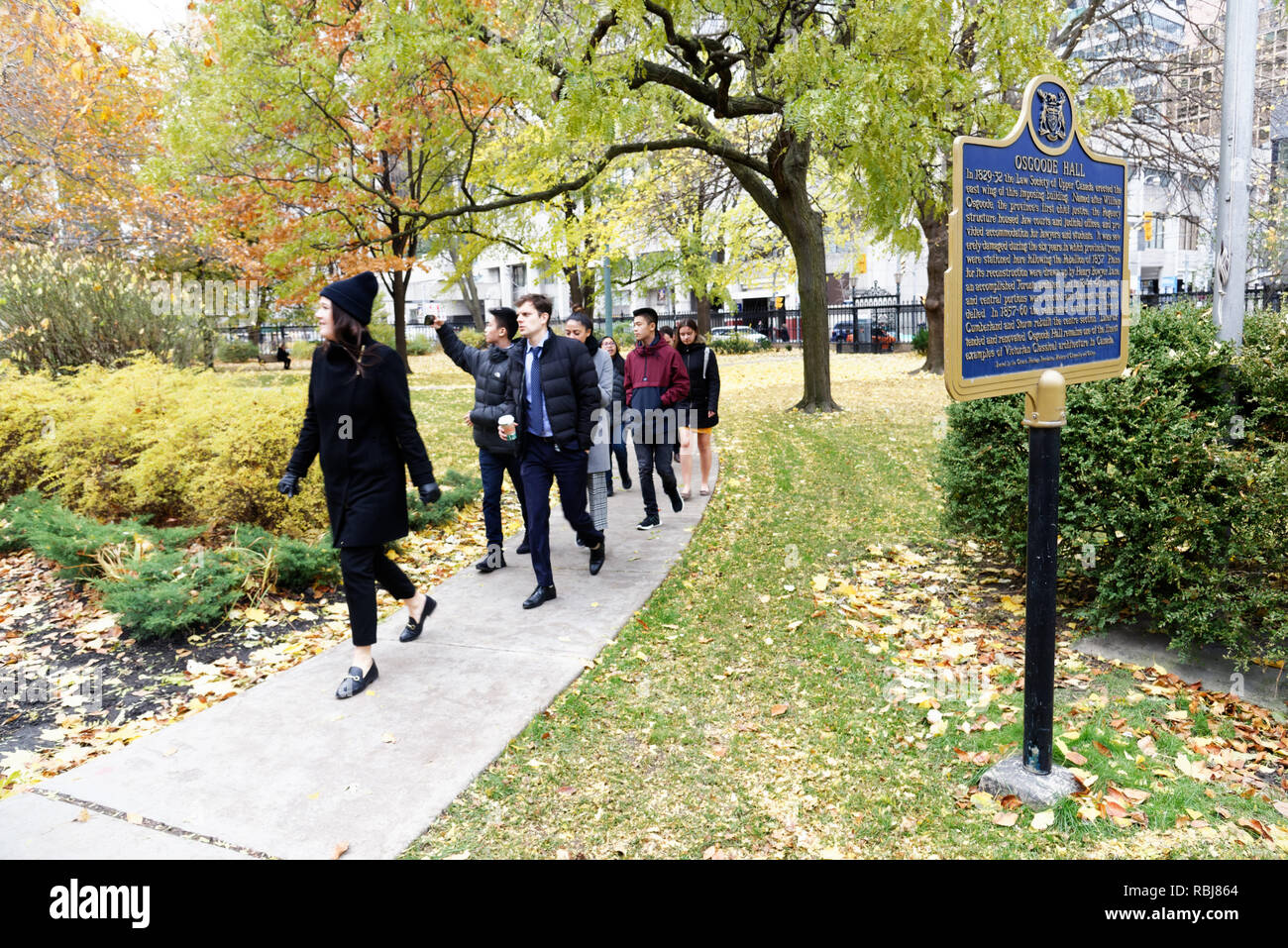 People walking through the gardens of Osgoode Hall in Toronto, Canada Stock Photo
