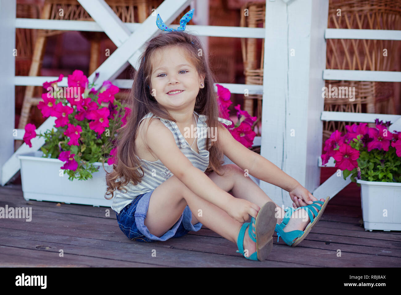 Stylish beautifull cute baby girl with brunette hair posing on ...