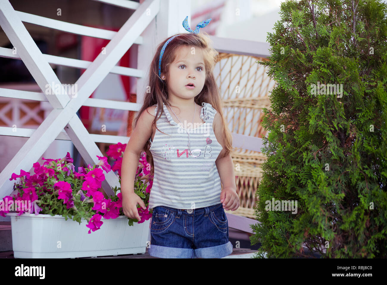 Stylish beautifull cute baby girl with brunette hair posing on ...