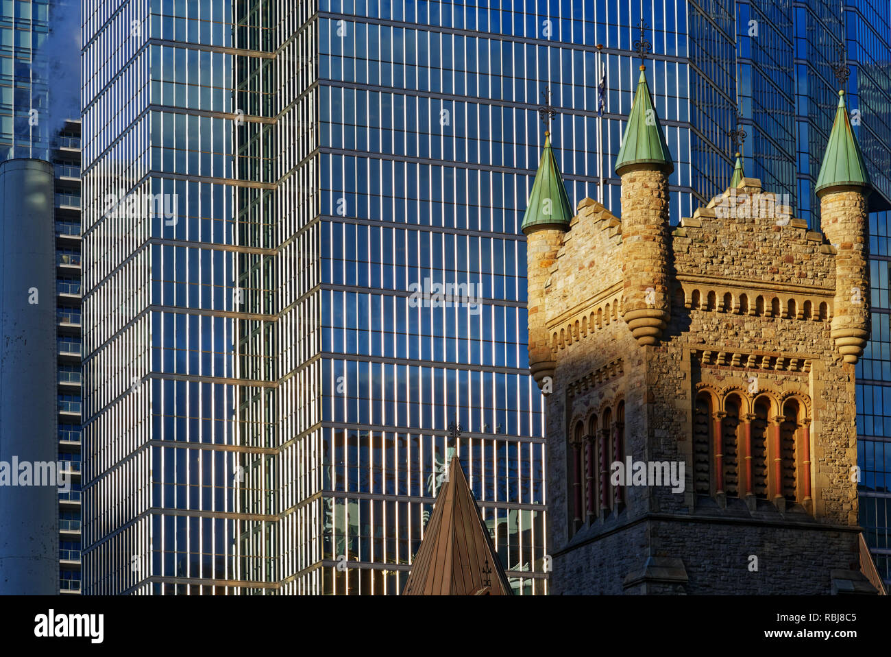 The Tower of St Andrew's Church in Toronto with the Bank of Montreal (BMO) Building behind Stock Photo