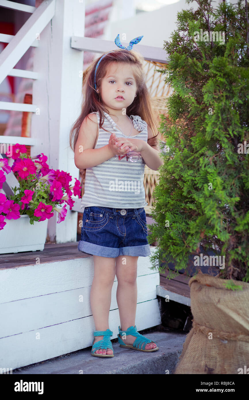 Stylish beautifull cute baby girl with brunette hair posing on ...