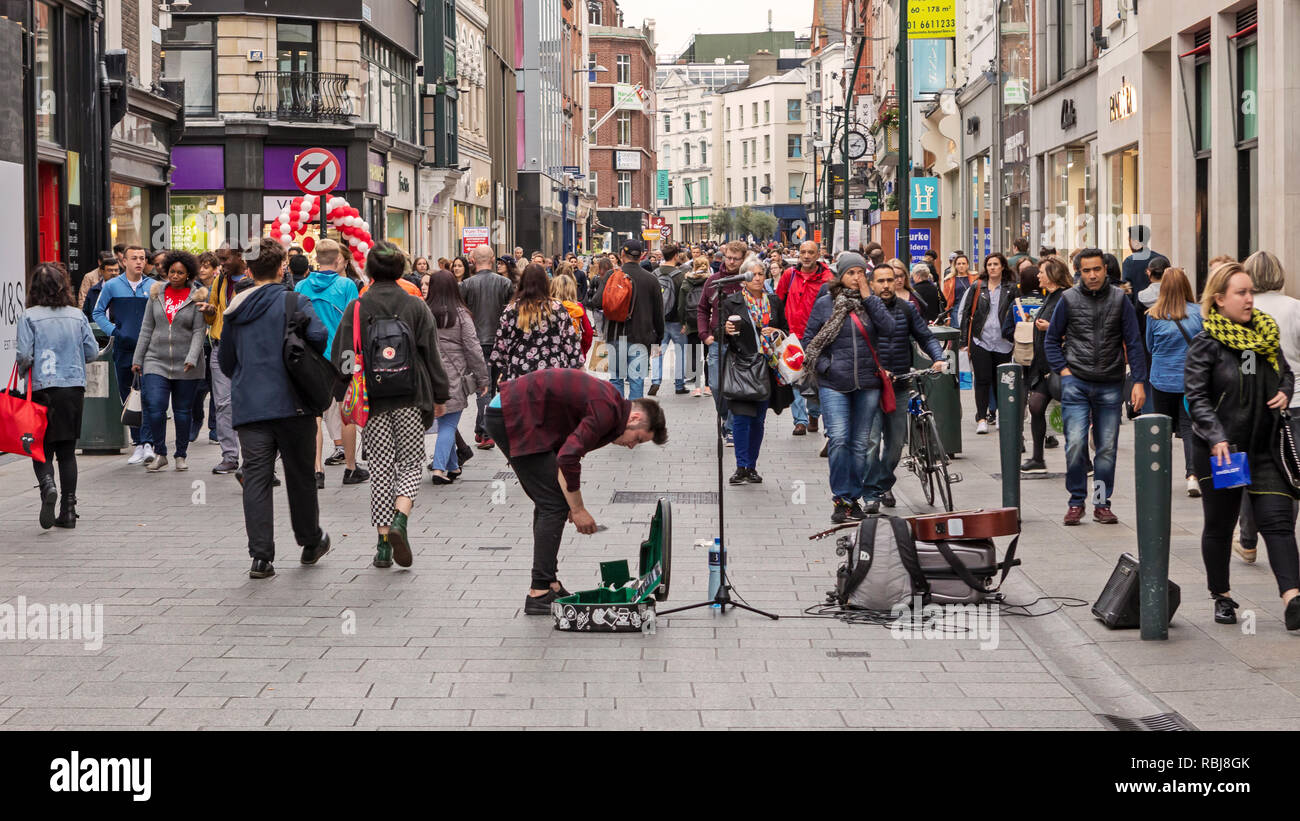 People, families, tourists walking and exploring Grafton St., a busy
