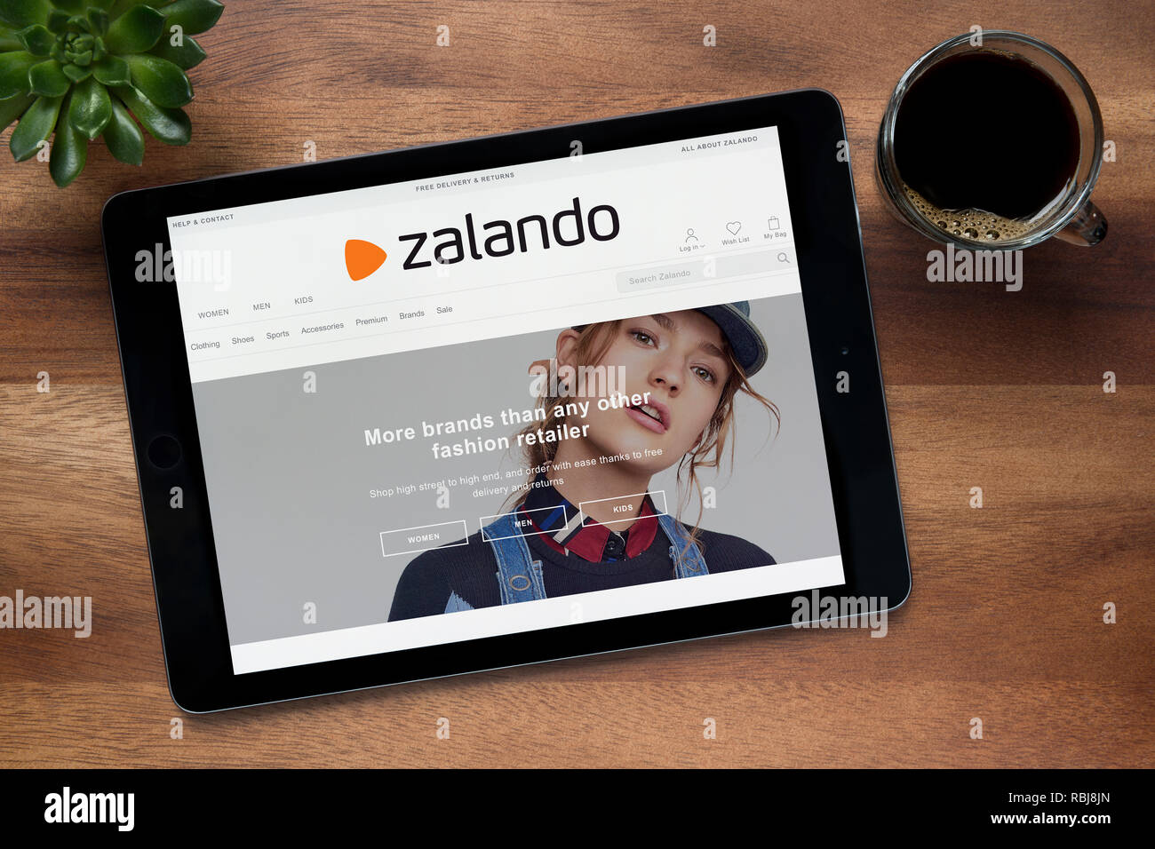 The website of Zalando is seen on an iPad tablet, on a wooden table along  with an espresso coffee and a house plant (Editorial use only Stock Photo -  Alamy