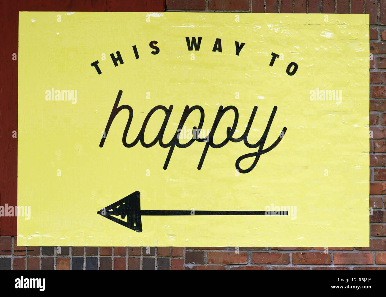 An arrow poins to "This way to Happy at Happy Place play area in Toronto, Canada Stock Photo