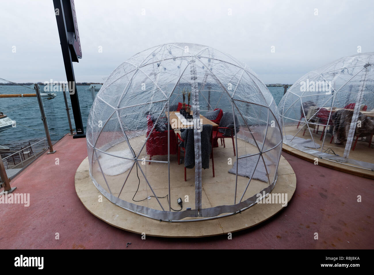 Heated outdoor plastic igloos at a pub in Toronto for dining outside in winter Stock Photo