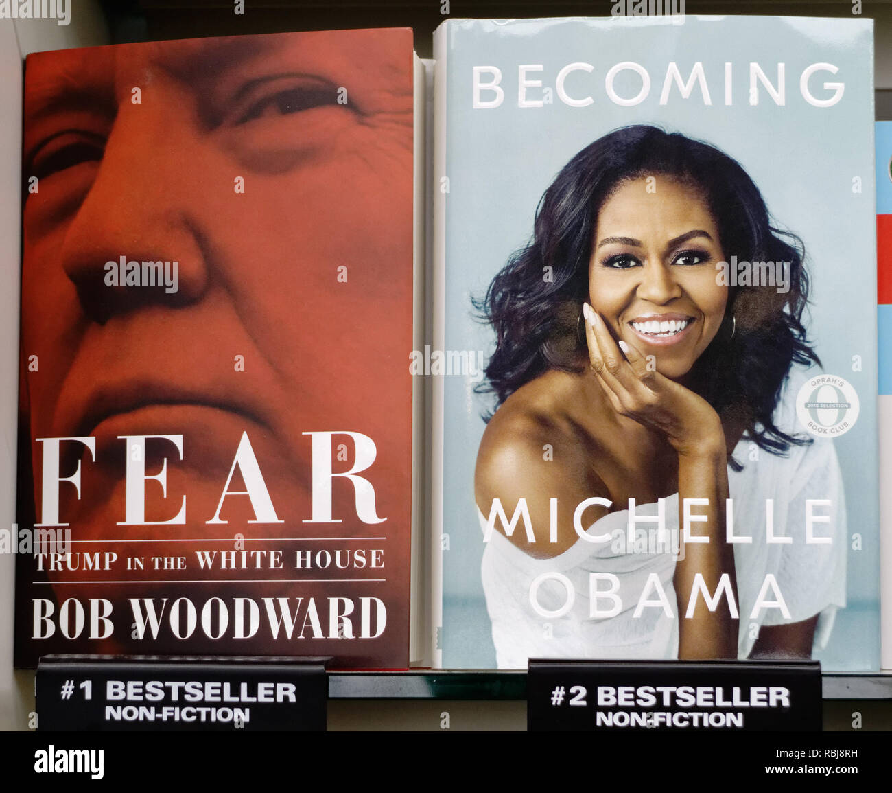 Fear: Trump in the White House and Becoming by Michelle Obama books side by side on a shelf in a shop Stock Photo