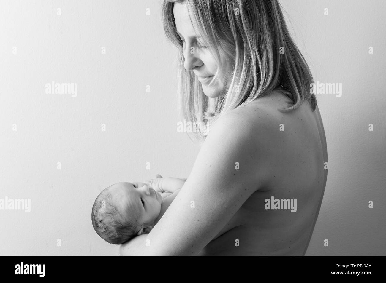 Mother holding newborn baby Stock Photo
