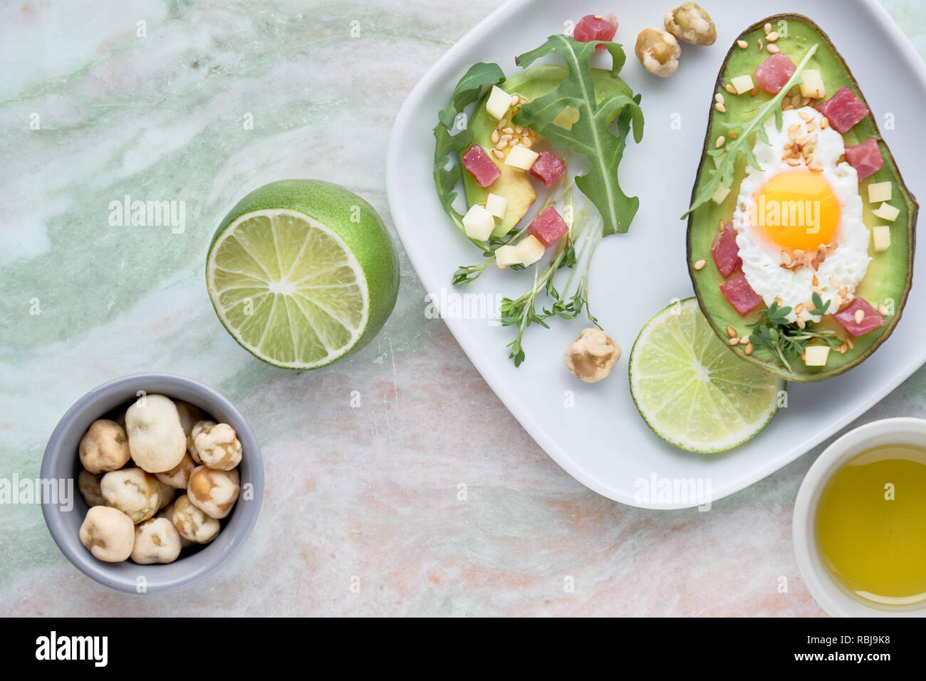 Keto diet dish baked Avocado boat with ham cubes, quail egg and cheese