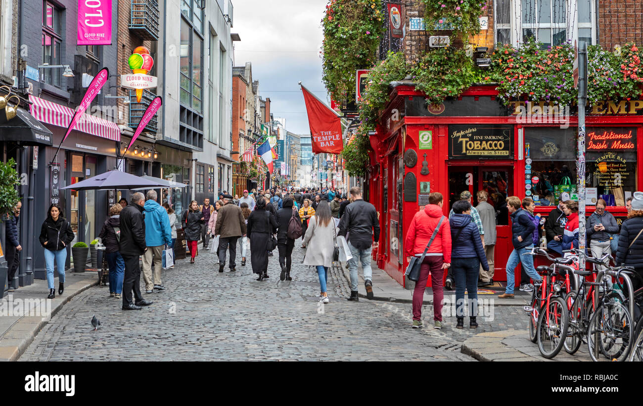 Visitors and tourists explore the Temple Bar district in Dublin, Ireland. Stock Photo