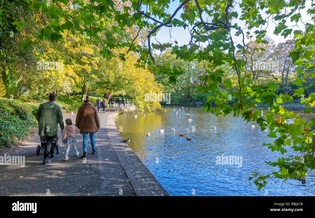 Families and friends walking and exploring the grounds on St. Stephen's Green in Dublin, Ireland. Stock Photo