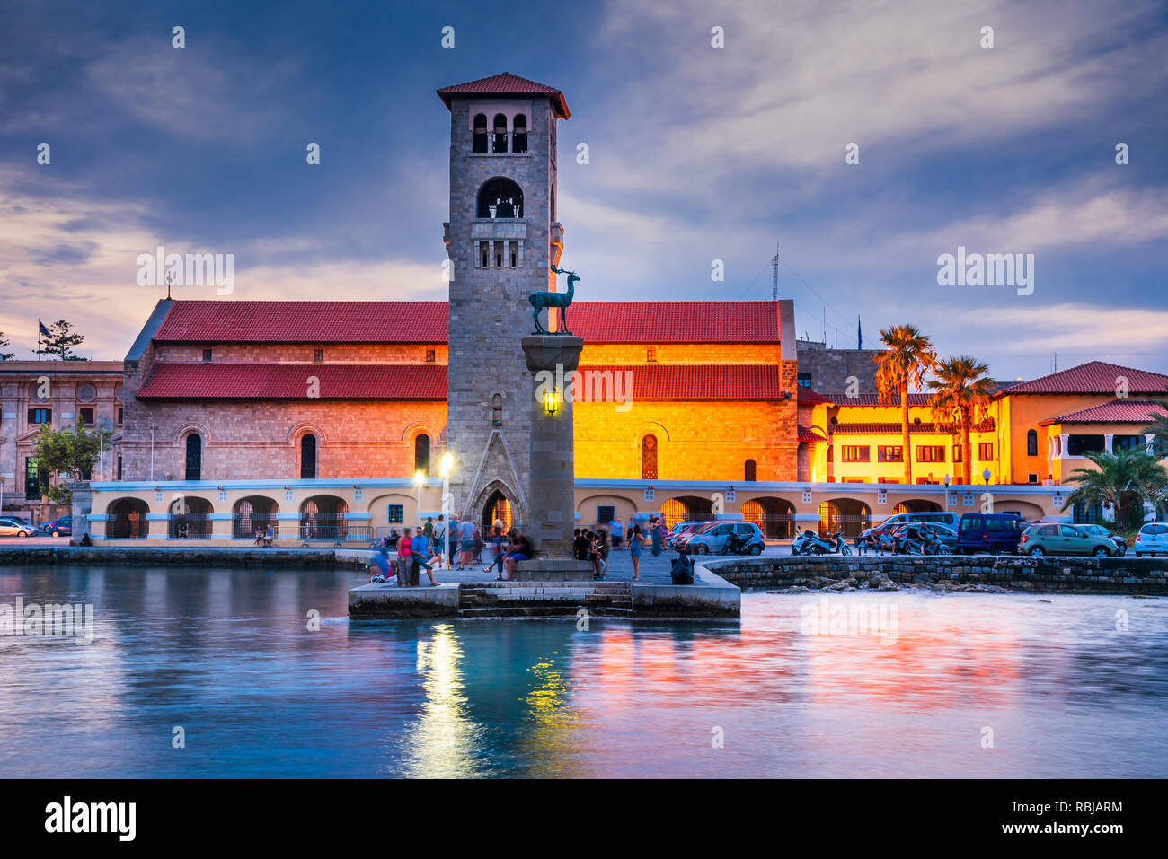 Rhodes, Greece. Stunning sunset image Mandraki harbour and Evaggelismos Church the place of Colossus of Rhodes. Stock Photo