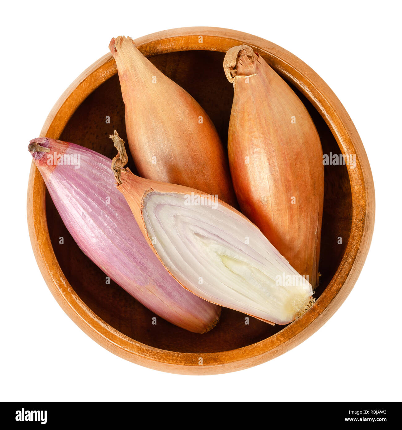 Long shallots, whole and sliced, in wooden bowl. Type of onion, Longor, French variety of Allium cepa. Purple, edible, raw, organic and vegan plant. Stock Photo