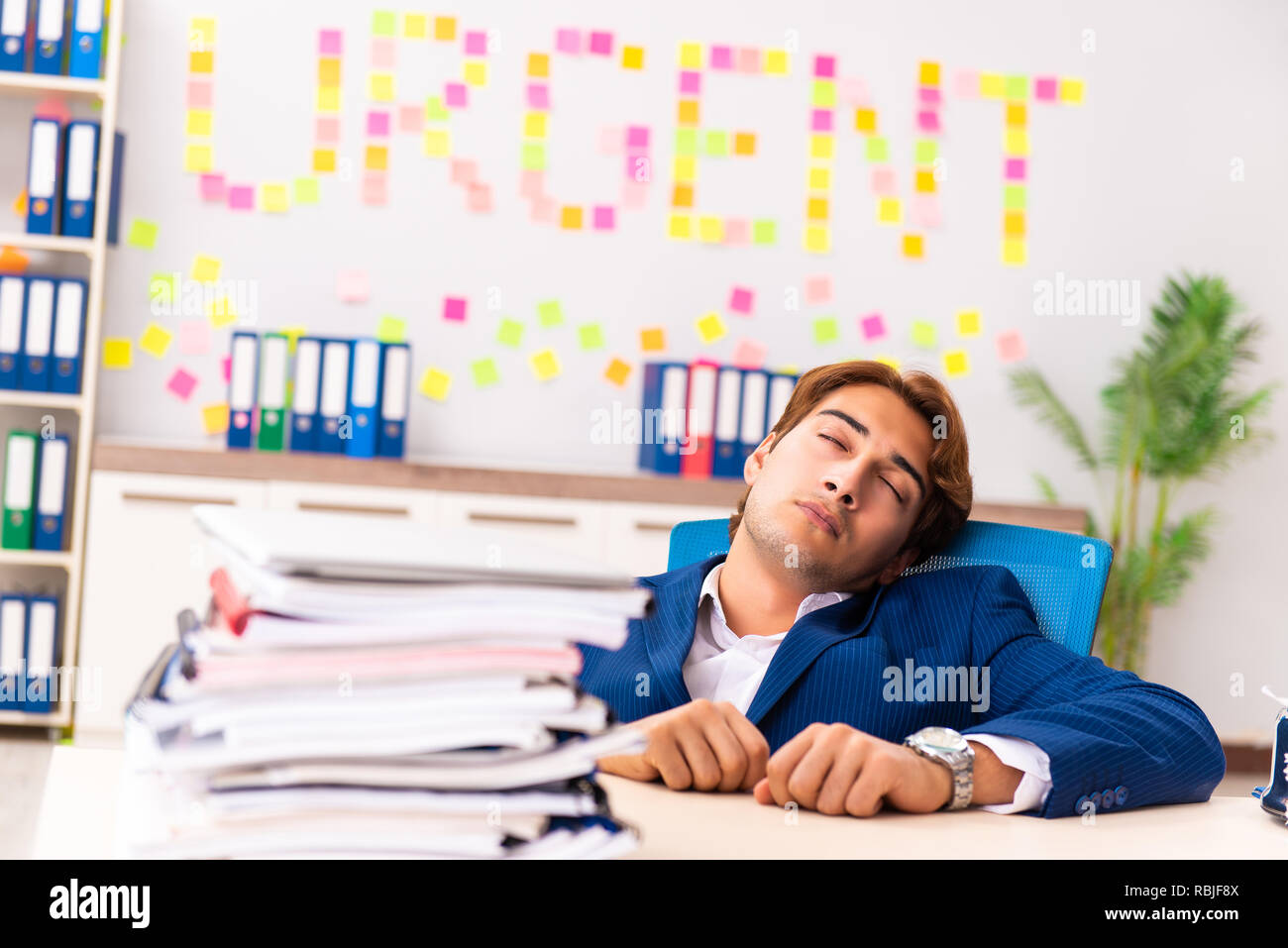 Young employee suffering from excessive work Stock Photo