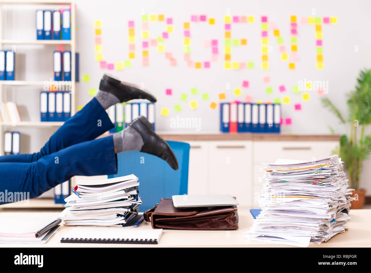 Young employee suffering from excessive work Stock Photo