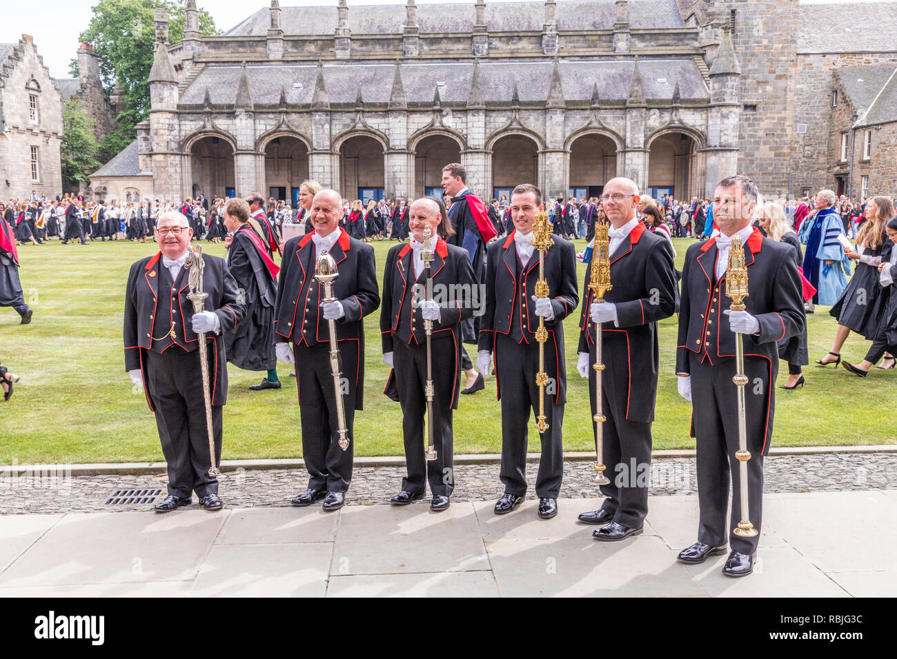 The mace bearers (the chief is the Bedelis) in St Salvators Quad after leading the procession for St Andrews University Graduation Day in June 2018 Stock Photo