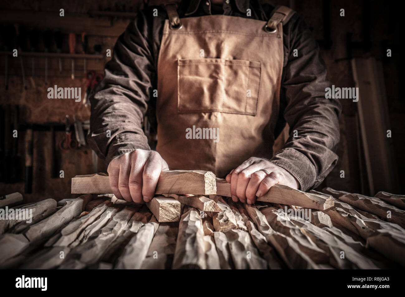 detail of carpenter holding carved wood Stock Photo