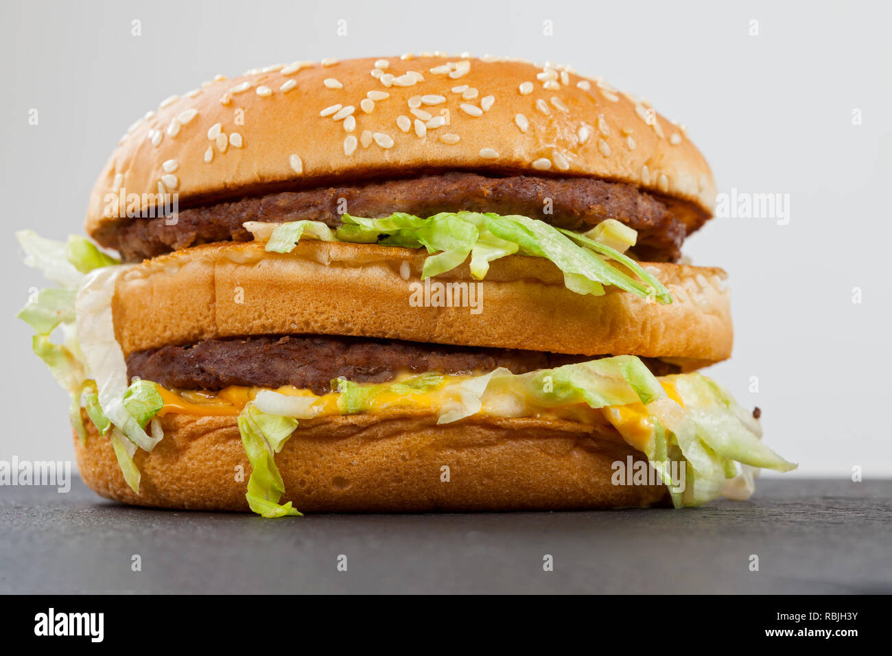 Close up picture of a tasty double cheeseburger with beef, cheddar, lettuce in a sesame bun Stock Photo