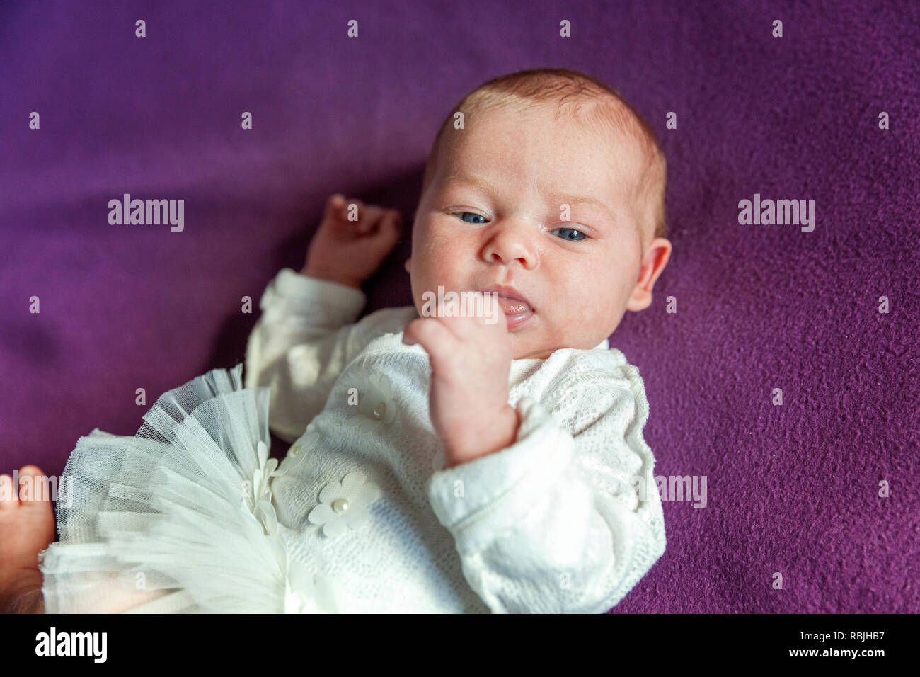 Soft Portrait Of Peaceful Sweet Newborn Infant Baby Lying On Bed