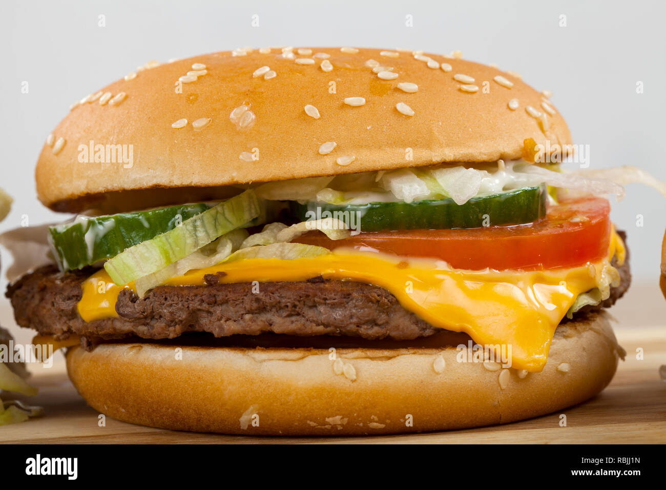 Close up picture of a tasty double cheeseburger with beef, cheddar, lettuce in a sesame bun Stock Photo