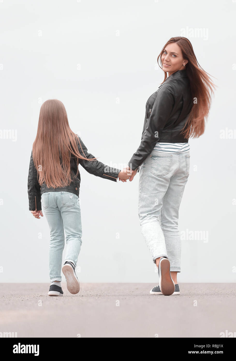 rear view. happy mother and daughter walk together Stock Photo - Alamy