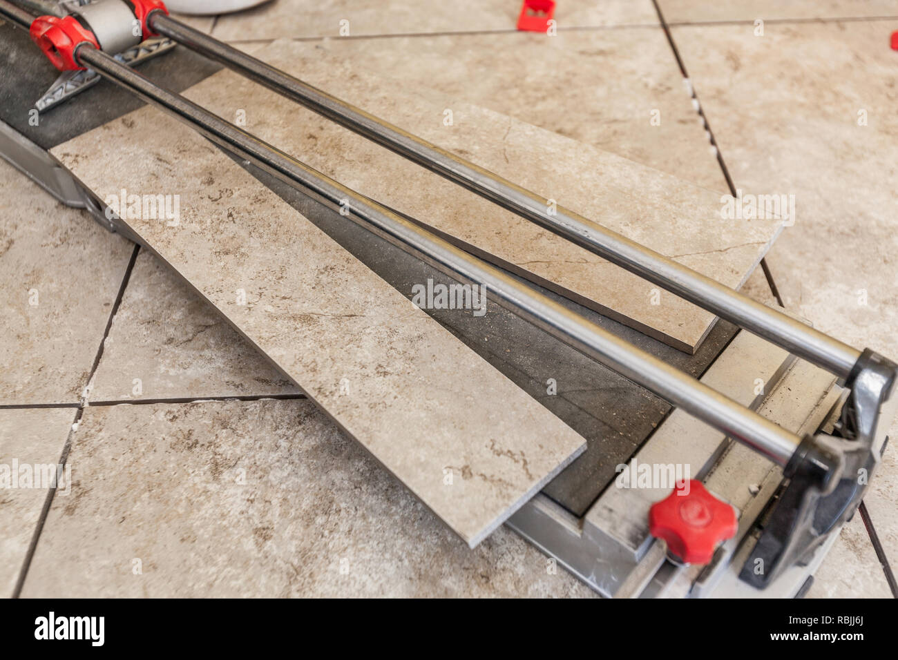 Using A Tile Cutter On Floor Stock Photo