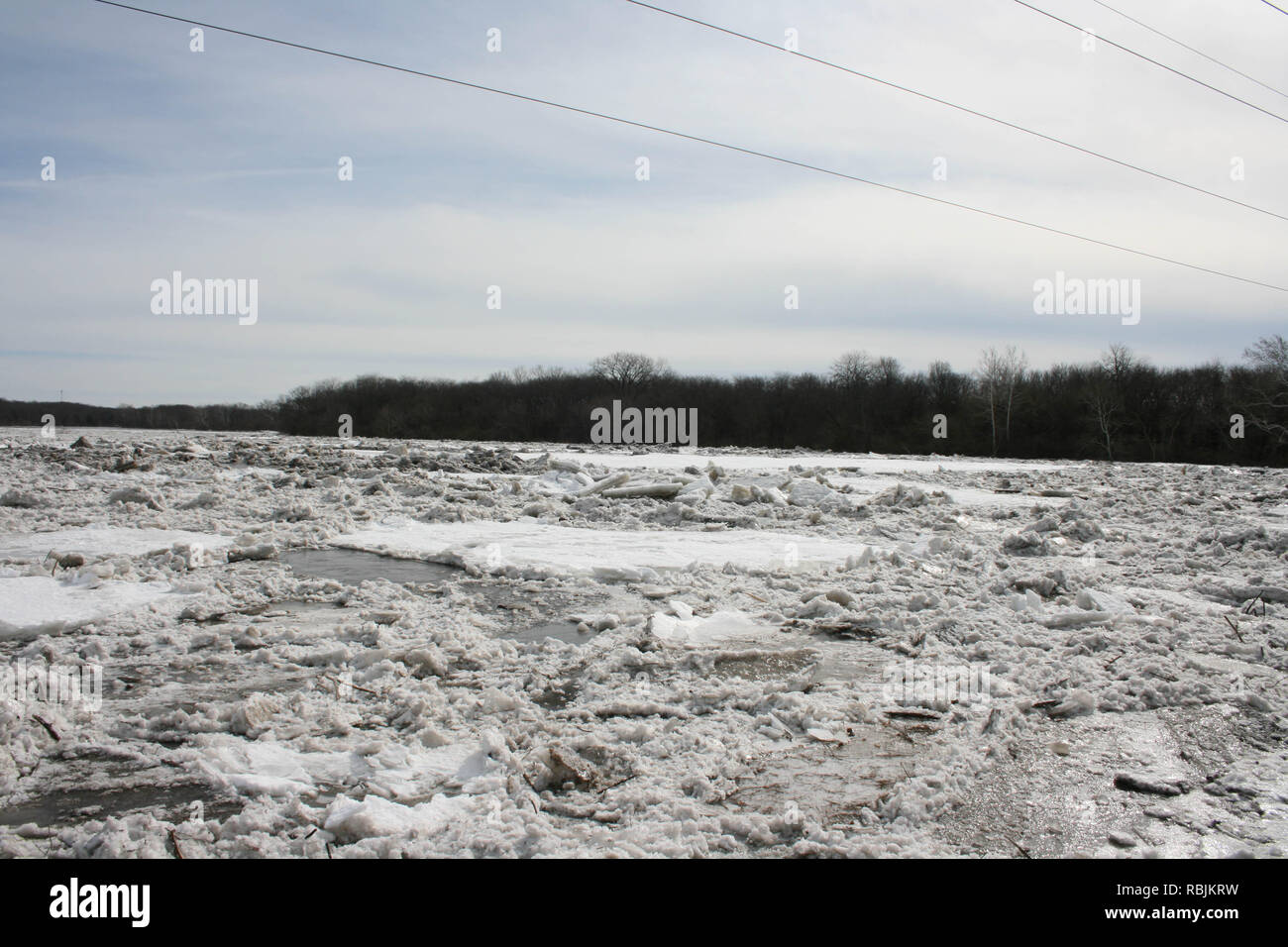 Winter ice jam on  the Kankakee River in Illinois USA right before it started to move from spring thaw. Stock Photo