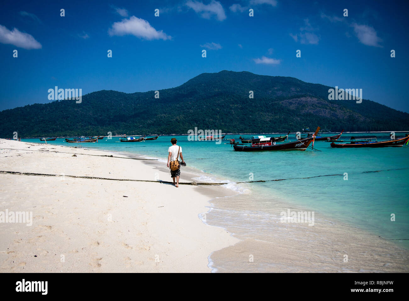 Man walking on the beach of Koh Lipe Stock Photo
