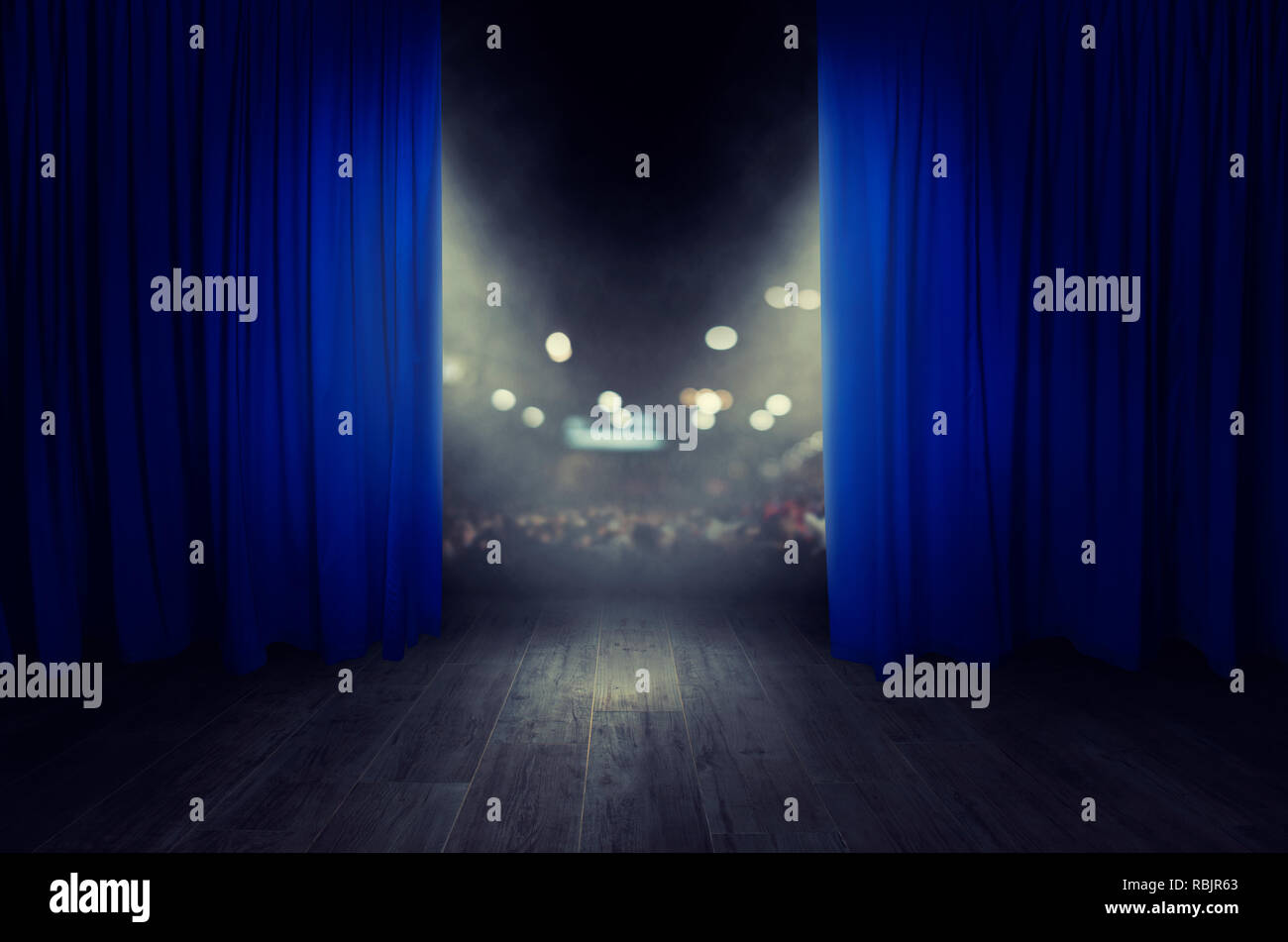 The blue curtains are opening for the theater show Stock Photo