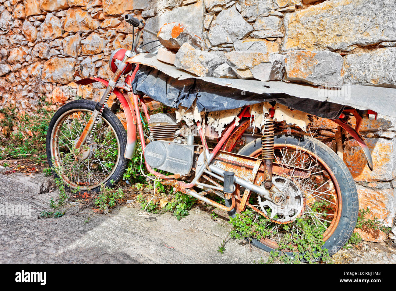 Ruined motorcycle in the medieval mastic village of Vessa on the island of Chios, Greece Stock Photo
