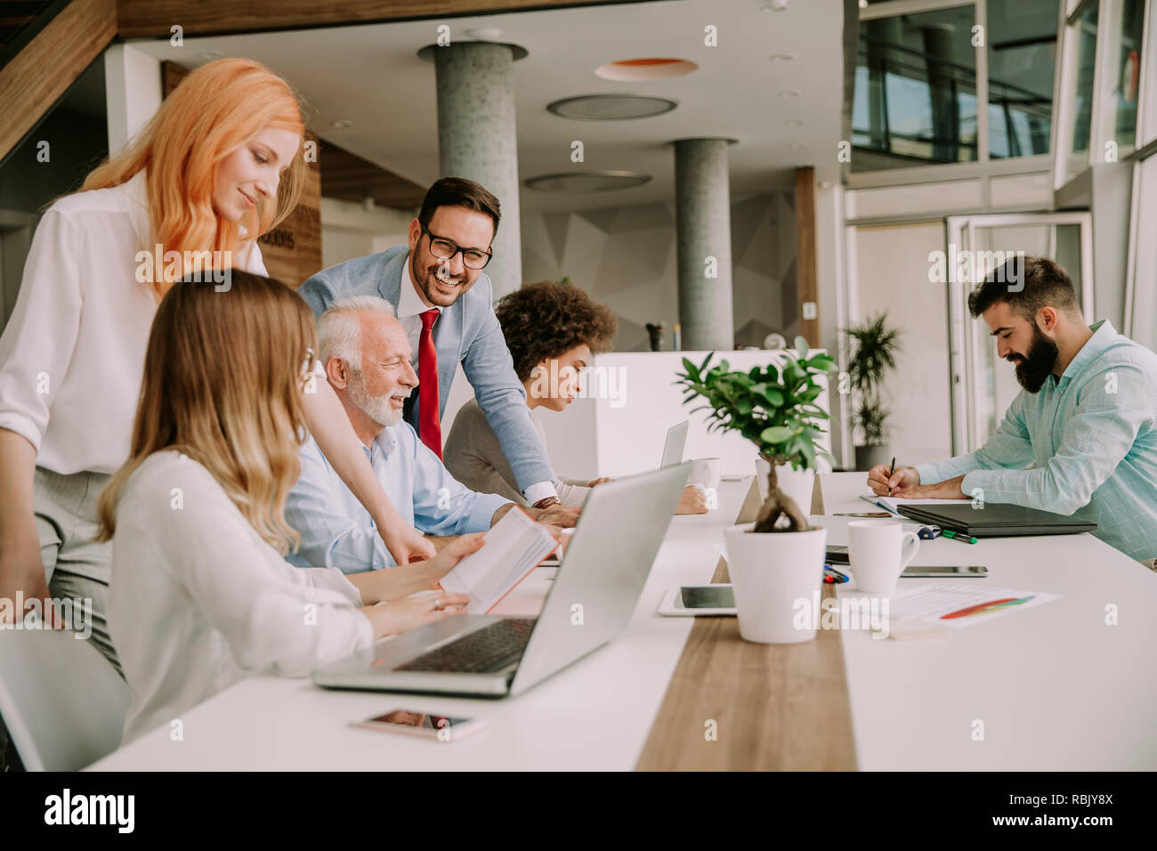 Group of businessmen and businesswomen working together in the modern ...