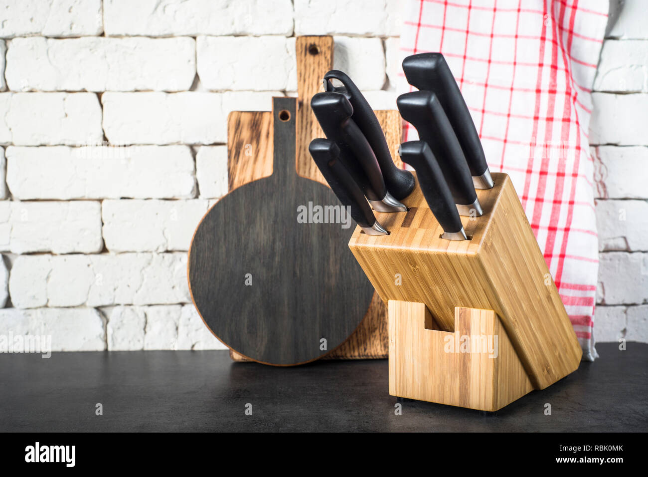 Kitchen knives set, cutting boards and towel on the kitchen tabl Stock