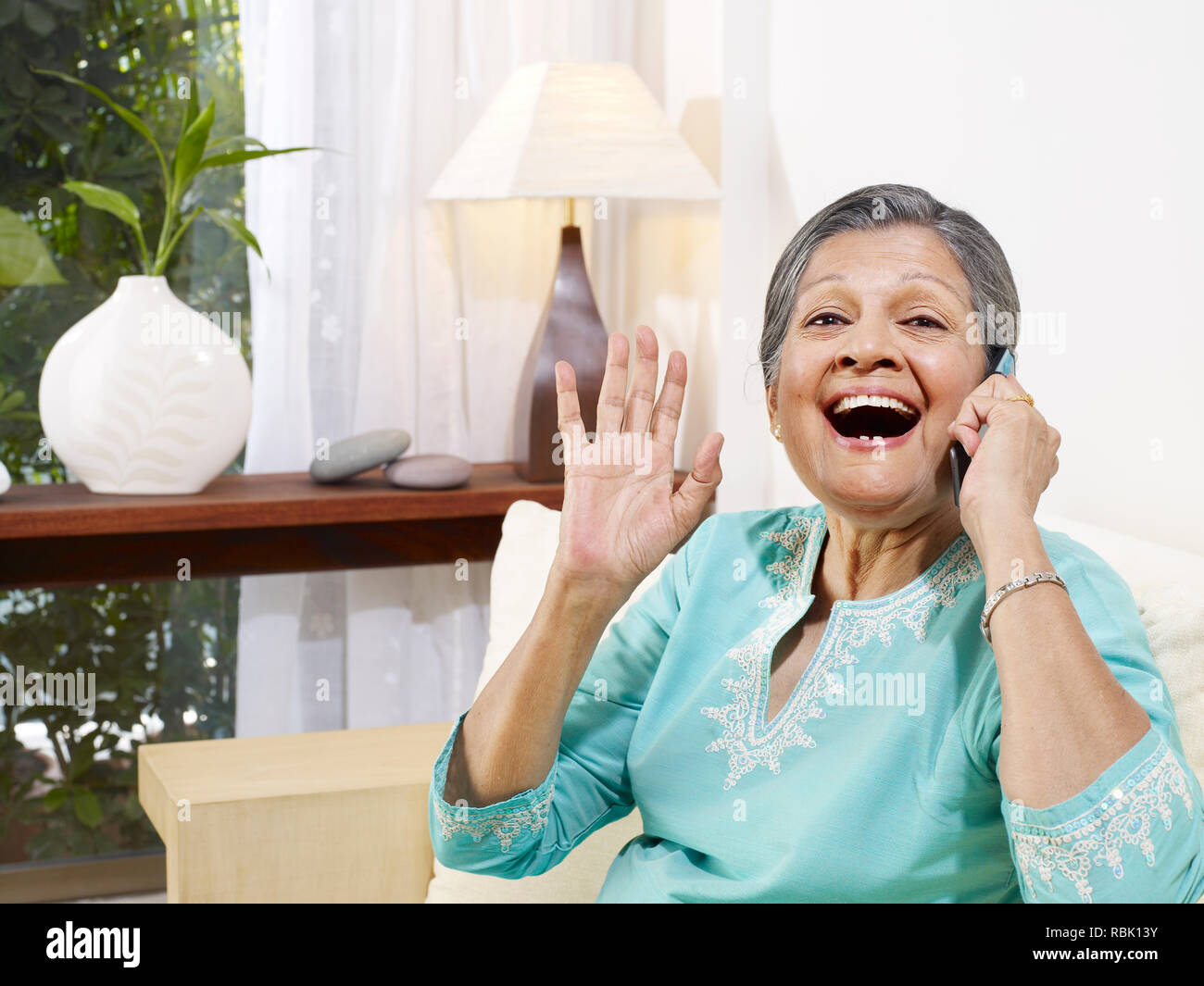 OLD WOMAN TALKING ON A MOBILE PHONE FROM HER HOME Stock Photo - Alamy