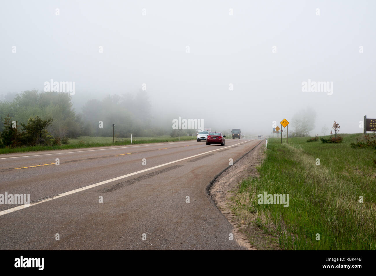 Marquette; Michigan.  Fog covers the road on highway 28 outside Marquette. Stock Photo