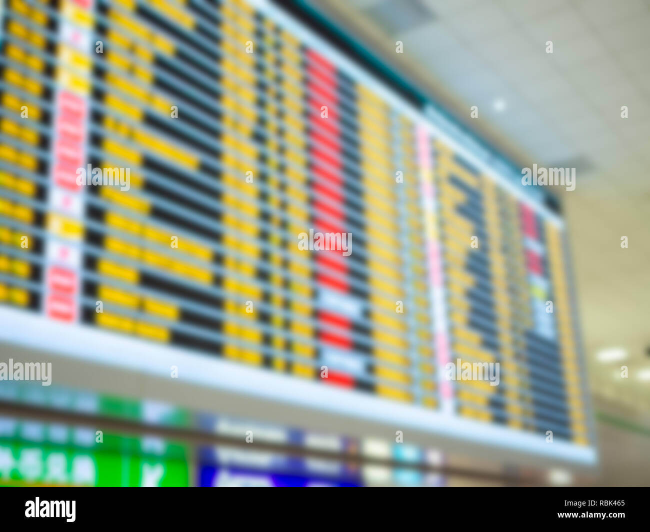 Blurred colorful boarding time monitor screens in airport. Stock Photo