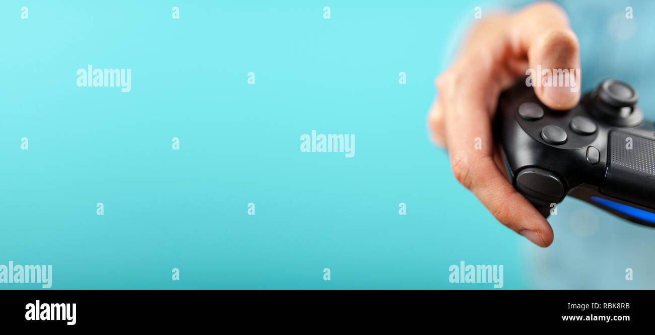 Male hands holding a gaming controller Stock Photo