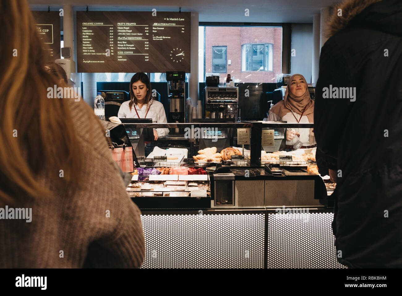 London, UK - January 5, 2018: People at the till inside Pret a Manger, a popular international sandwich shop chain that is based in UK and has approxi Stock Photo