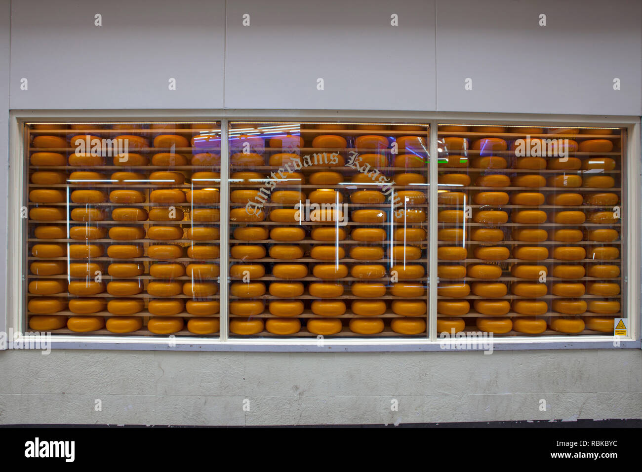 Dutch cheese shop with a window full of cheeses, Amsterdam, Netherlands. Stock Photo