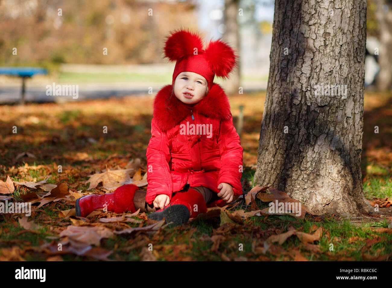Dolly pin-up toothsome young girl wearing red blushful winter jacket and  warm hat with boots fashion stylish clothes posing in autumn spring park  week Stock Photo - Alamy