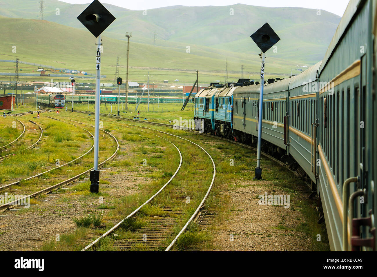 Transsiberian Railway taking a turn in rural Mongolia with another oncoming train near Ulanbaatar (Ulaanbaatar, Mongolia, Asia) Stock Photo