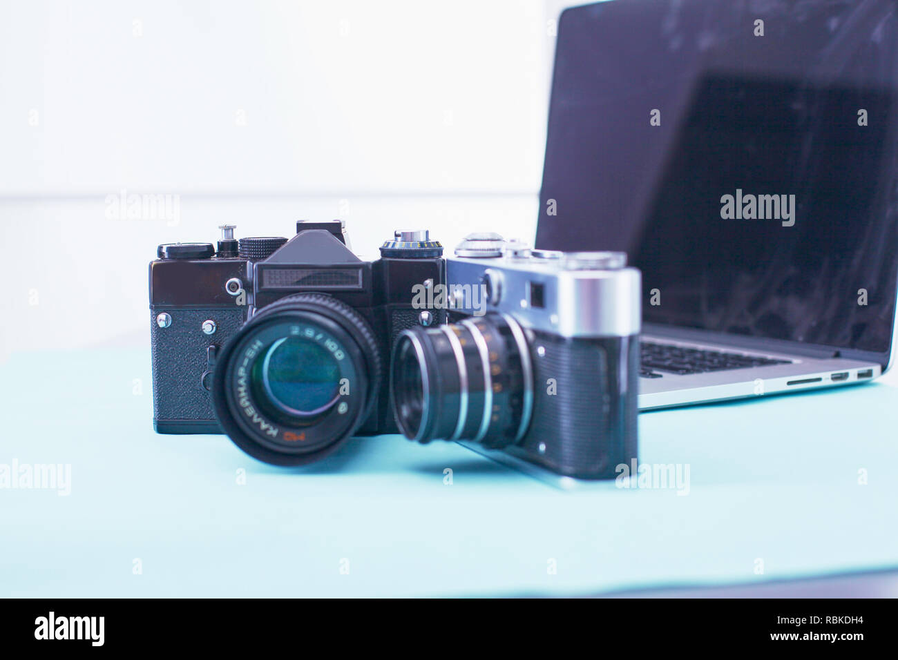 Computer keyboard, mouse and camera lie on table. Stock Photo